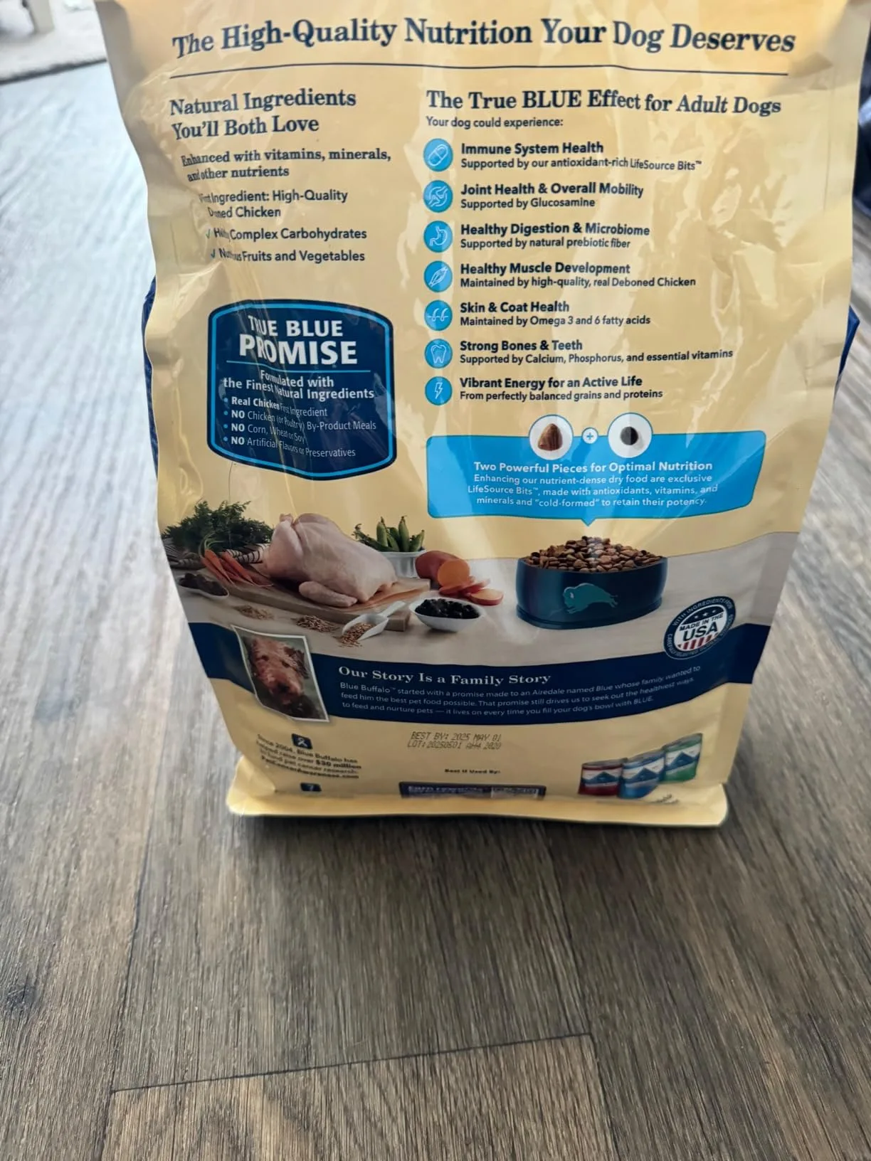 A golden retriever sniffing a bowl of Blue Buffalo kibble next to the 5lb bag